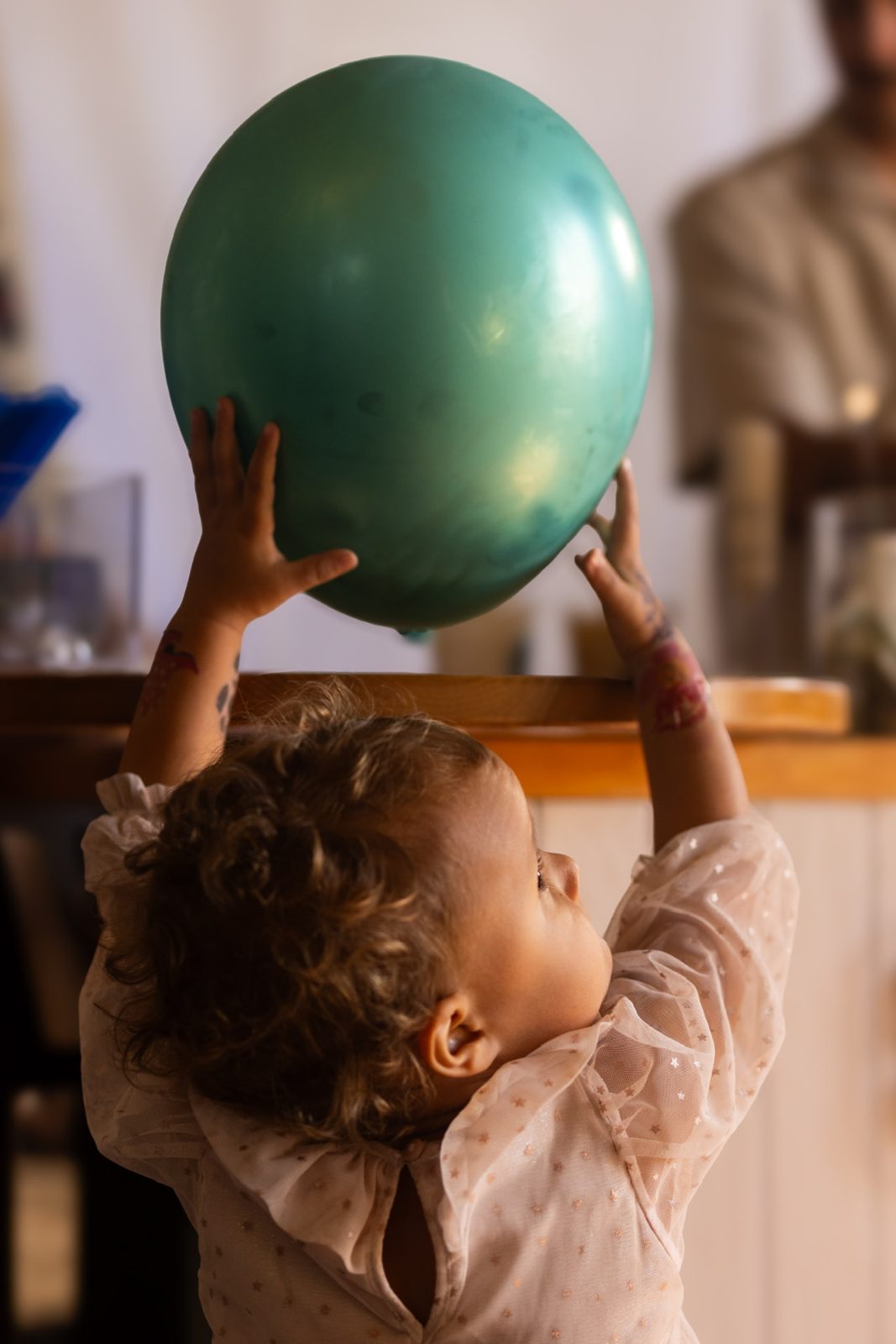 A child holding a balloon at a Slow Down Coffee day party